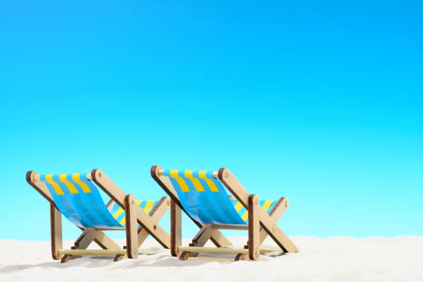 istock Two sunbeds at the beach on background of blue sky 701100628