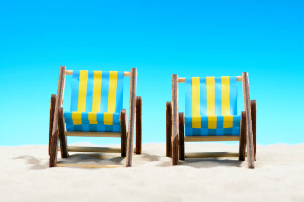 istock Two sunbeds at the beach on background of blue sky 701100642