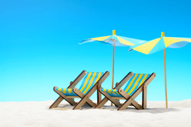 istock Two sunbeds at the beach on background of blue sky 701100644