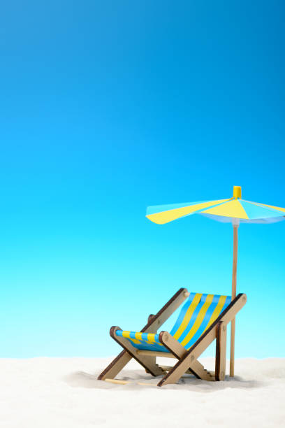 istock Sunbed at the beach on background of blue sky 701100666