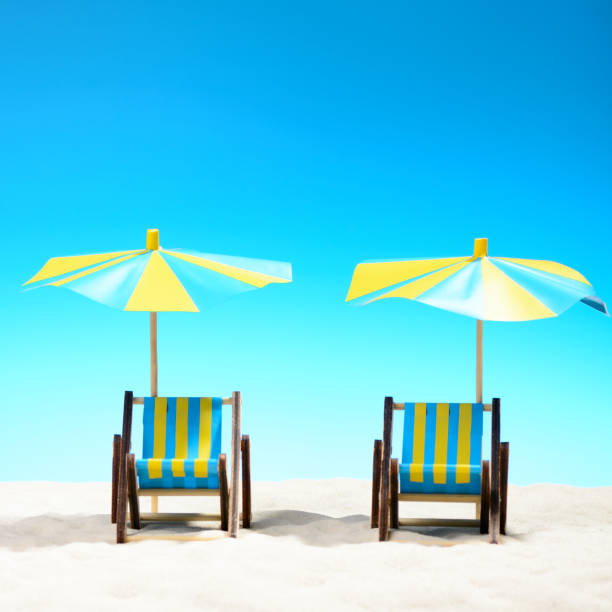 istock Two sunbeds at the beach on background of blue sky 701100696