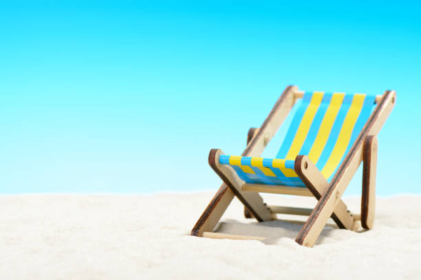 istock Sunbed at the beach on background of blue sky 701100772