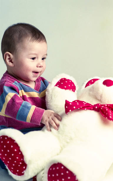 istock Baby Boy Playing with Stuffed Bear 701103656
