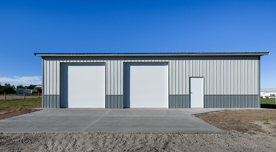 Garage in suburb area, USA. Concrete apron, driveway