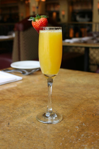 istock Single mimosa cocktail glass, vertical 701120682