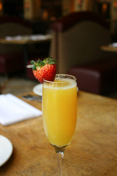 istock Single mimosa cocktail glass, above, vertical 701124734