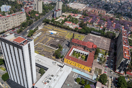 Mexico City, Mexico, March 16, 2015, aerial view of ancient Aztec ruins beside a colonial church and modern building in Tlatelolco district, close to the center of Mexico City. Because of the combination of different aged building this place is called the three culture plaza