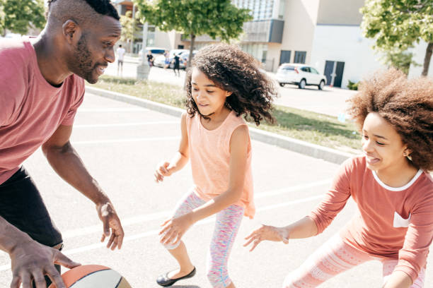 istock Playing basketball with dad and sister 701152188
