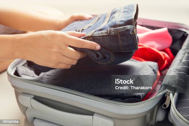 Close Up Of Businesswoman Packing Clothes Into Travel Bag Luggage And People Concept Stock Photo - Download Image Now