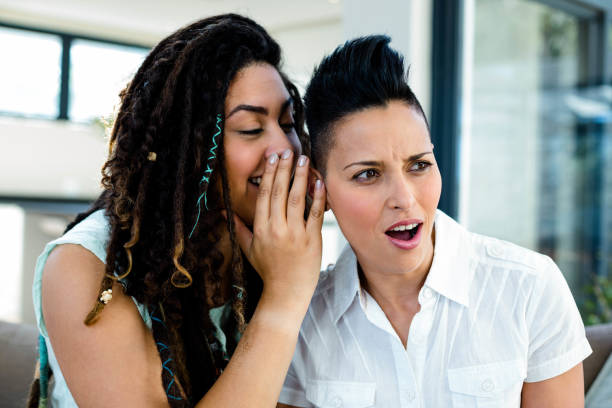 istock Lesbian couple whispering in ear 701181236