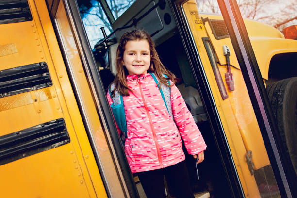 istock Girl on School Bus 701184302