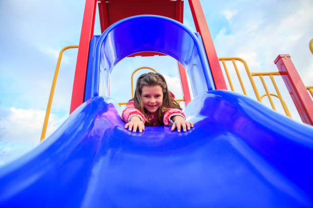istock Girl at Playground Slide 701184308