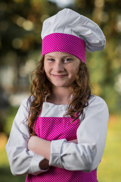 Cooking lover Portrait of a young girl wearing a chef's whites chefs whites stock pictures, royalty-free photos & images