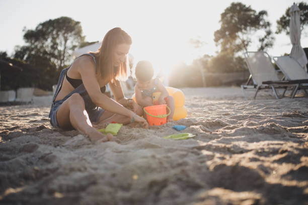 istock Mother and baby daughter playing together 701188982