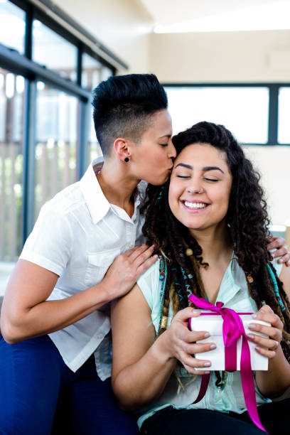 istock Woman receiving a gift from her partner 701193558