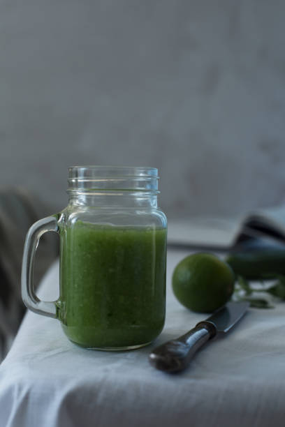 istock Fresh organic green smoothie with spinach, cucumber on a white tableware 701193768