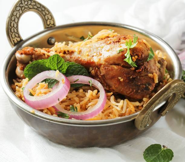 istock Chicken Biryani on white background served in a traditional Kadai, selective focus 701206046
