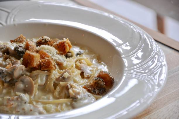 istock Delicious spaghetti carbonara on wooden table 701206110