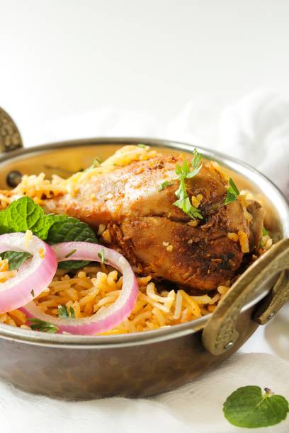 istock Chicken Biryani on white background served in a traditional Kadai, selective focus 701206162