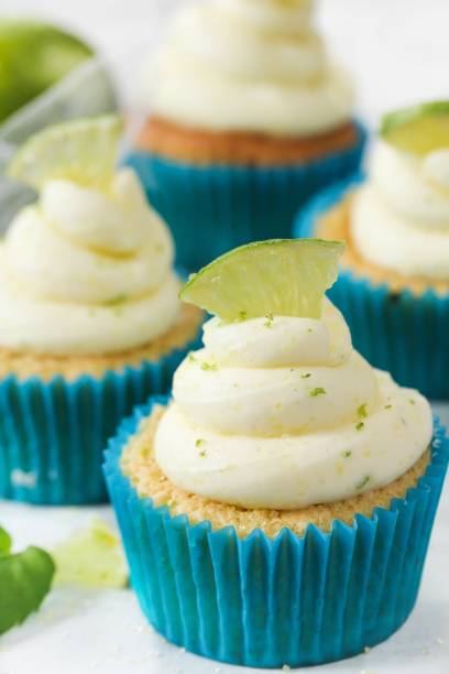istock Homemade Key lime cupcakes with cream cheese lime zest frosting, selective focus 701211526