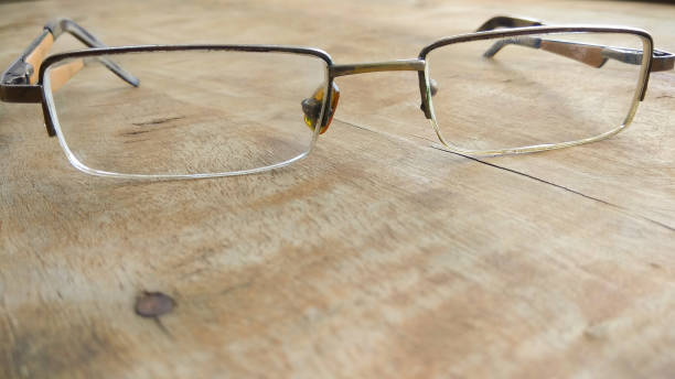istock eye glasses on wooden background. 701211744