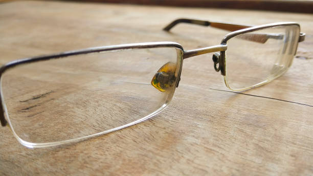 istock eye glasses on wooden background. 701211762