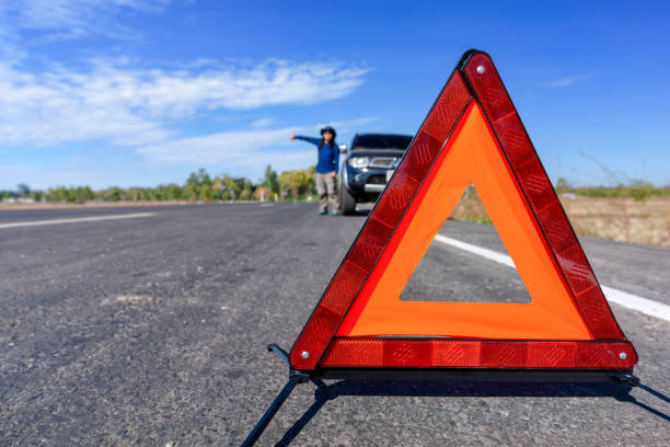 istock Red emergency stop sign and broken car on the road 701216758