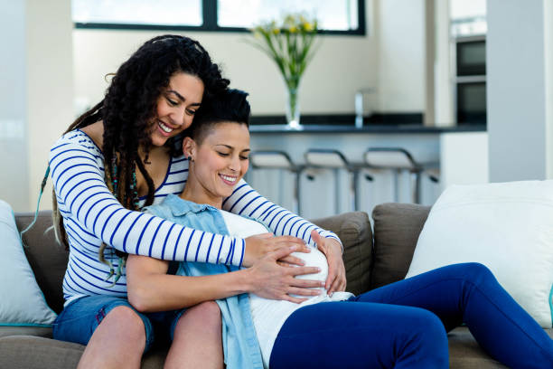 istock Woman touching pregnant partners stomach 701217192
