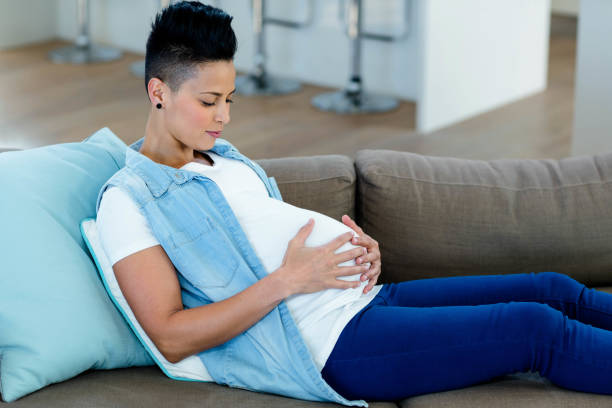 istock Pregnant woman relaxing on sofa 701217244