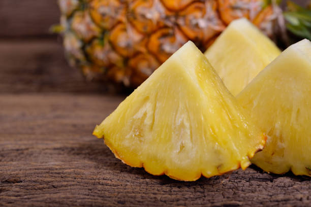 istock portion cout ripe pineapple on wooden table 701219672