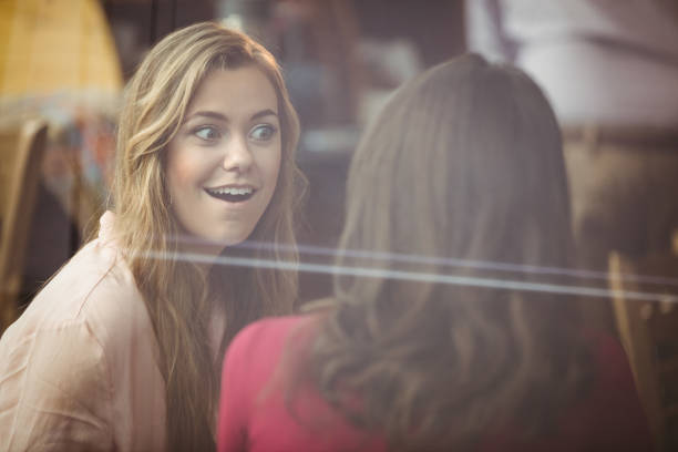 istock Pretty friends chatting over coffee 701222372