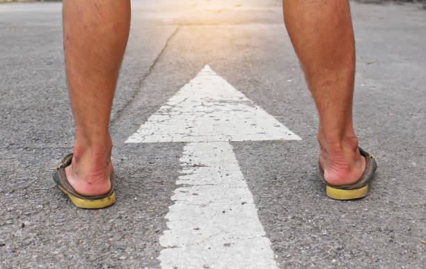 istock Man stand follow the arrow to be one. 701222784