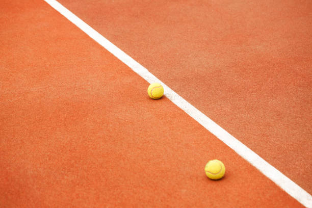istock Ball on tennis court background 701234062