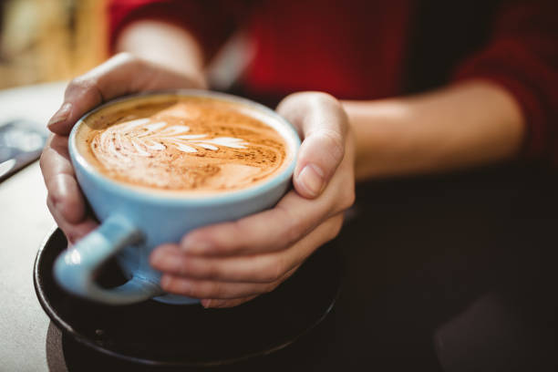 istock Woman holding a cup of coffee 701249240