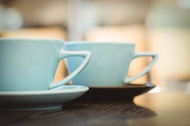 istock Cup of cappuccino with coffee art on wooden table 701249532