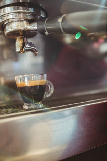 istock Close up of cup on a coffee machine 701249754