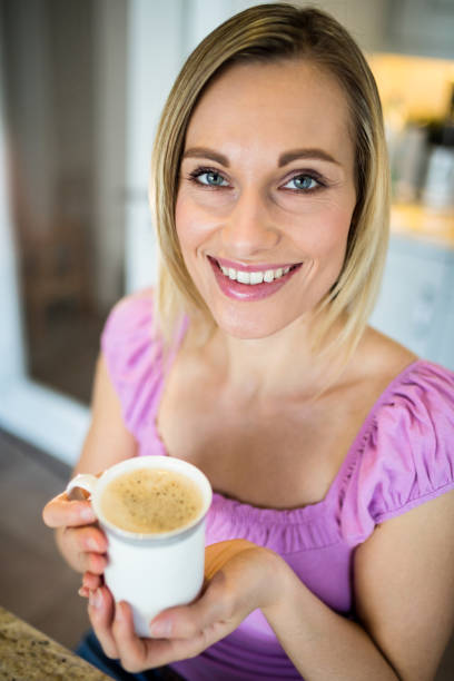 istock Pretty blonde woman having coffee 701258046