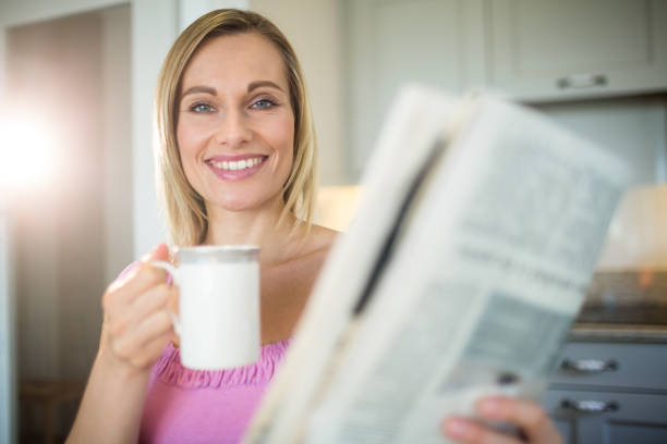 istock Pretty blonde woman having coffee 701260126
