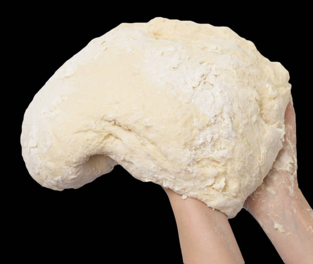 dough in hand on a black background