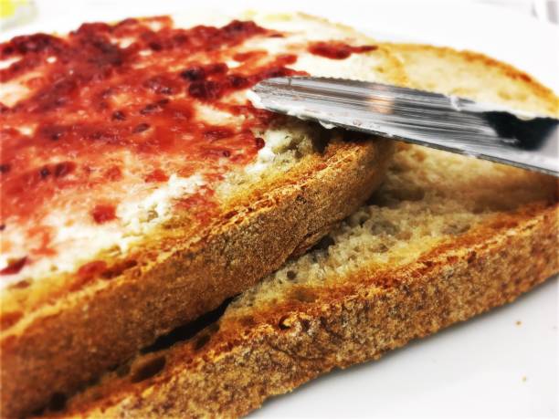 Close-Up Of Bread With Table Knife In Plate
