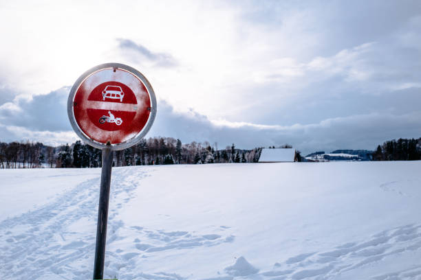 istock Metallic Sign On Snow Covered Road Against Cloudy Sky 705181685