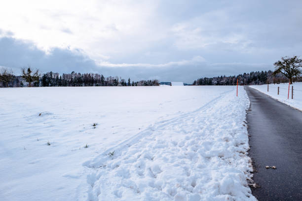 istock Road By Snow Covered Field Against Cloudy Sky 705183873