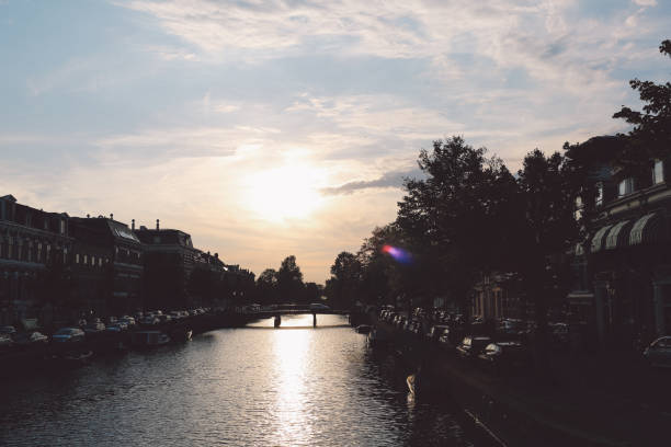 istock River Amidst Buildings Against Sky During Sunset 705208673