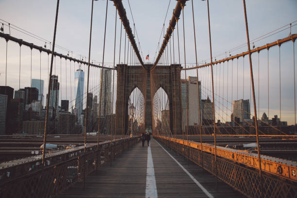 istock Suspension Bridge In City Against Sky During Sunset 707568863