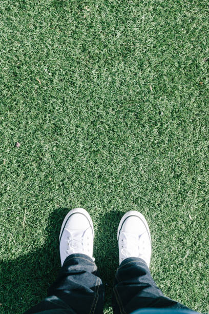 istock Low Section Of Man Standing On Grass 709181307