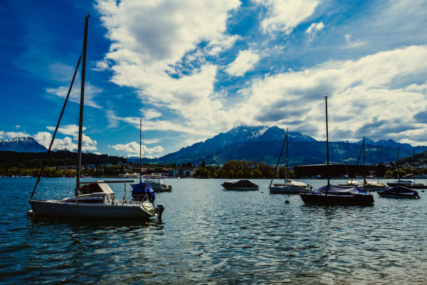 istock Boats Moored At River By Mountain Against Sky 709224813