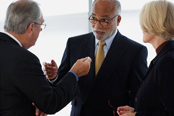 Three ceos having an argument  group of people men mature adult serious stock pictures, royalty-free photos & images
