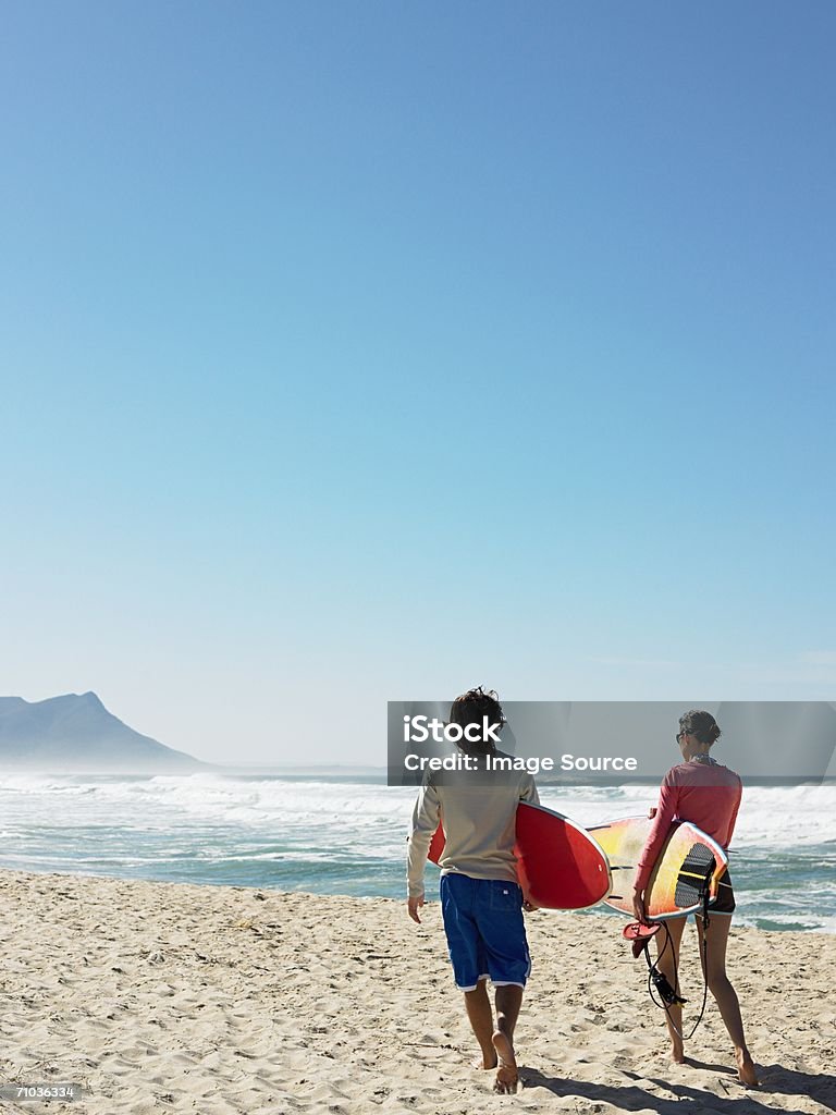 Couple going surfing  Adult Stock Photo
