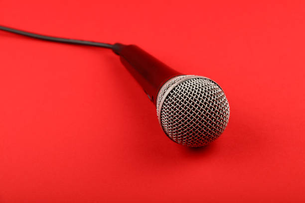 istock Close-Up Of Microphone On Red Background 713841037