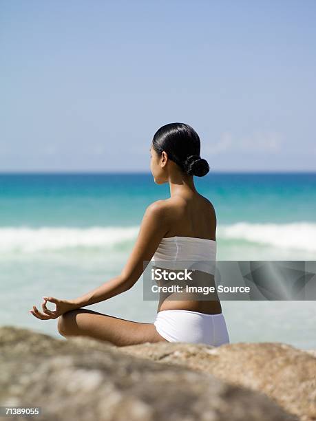 Woman Meditating By The Sea Stock Photo - Download Image Now - Adults Only, Color Image, Day